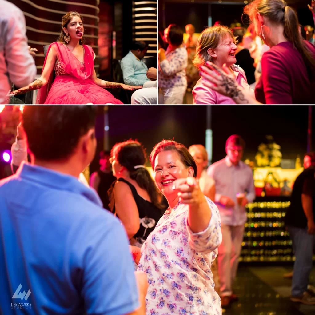 Guests joyfully dancing at a Mehendi celebration, showcasing vibrant traditional attire and lively movements as they participate in the festive event.