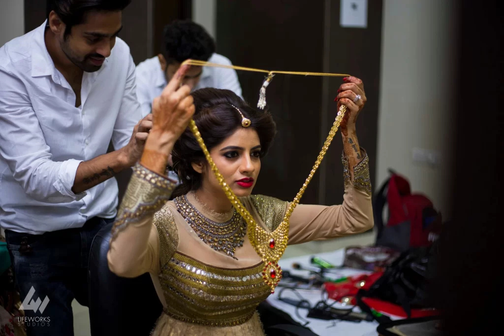 A photograph showcasing the bride getting ready for her wedding, surrounded by bridal attire, makeup, and accessories, as she prepares for the special day