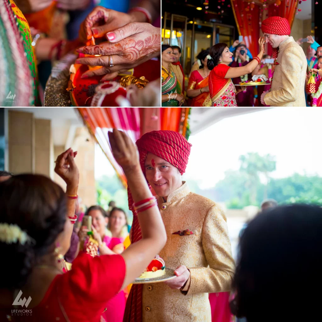 A touching moment captured as the groom receives a traditional tilak blessing from the bride's family, symbolizing the union of the two families and the start of matrimonial rituals.