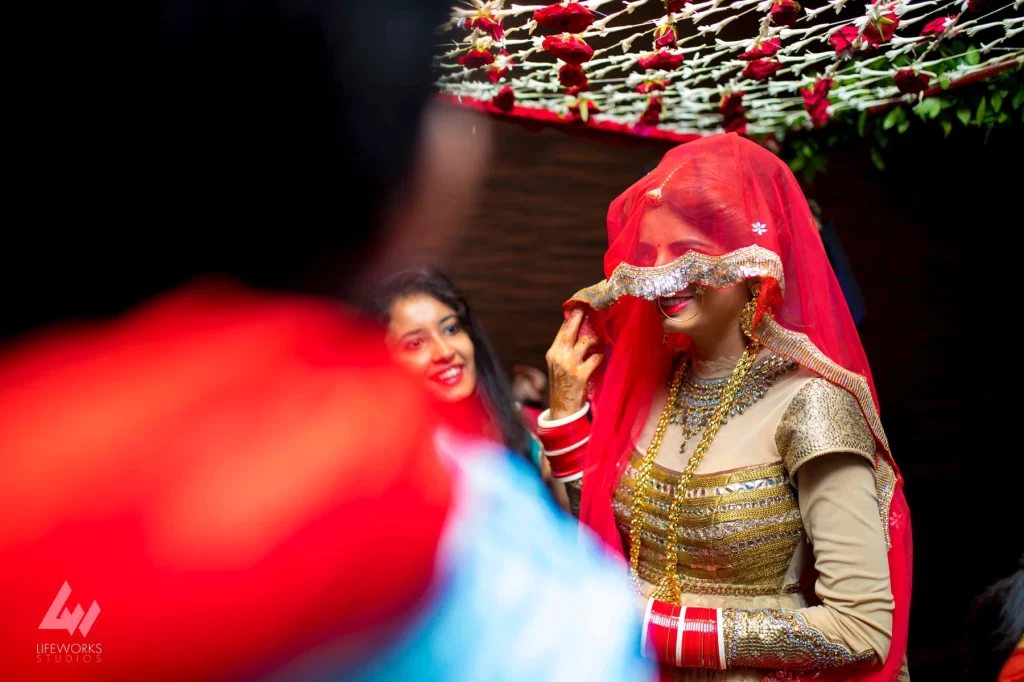 An image of the bride making a magnificent entry, dressed in exquisite wedding attire and adorned with traditional embellishments, exuding elegance and grace as she prepares to join her partner in marriage.