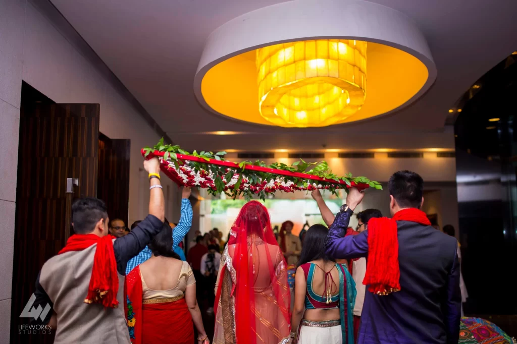 An image of the bride making a magnificent entry, dressed in exquisite wedding attire and adorned with traditional embellishments, exuding elegance and grace as she prepares to join her partner in marriage.