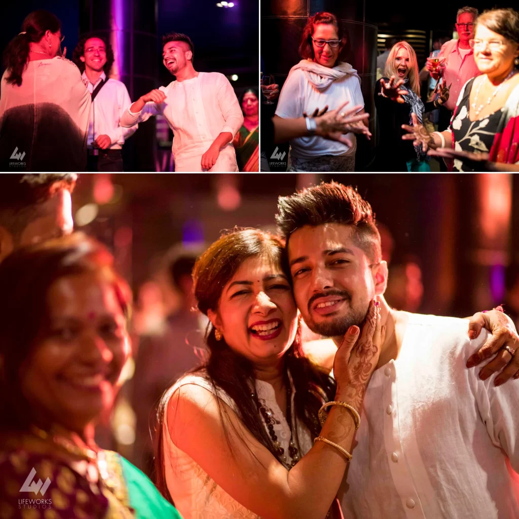 Guests at a mehendi function, laughing and enjoying themselves while participating in traditional celebrations. The atmosphere is vibrant and lively, with guests wearing colorful attire and engaging in festive activities