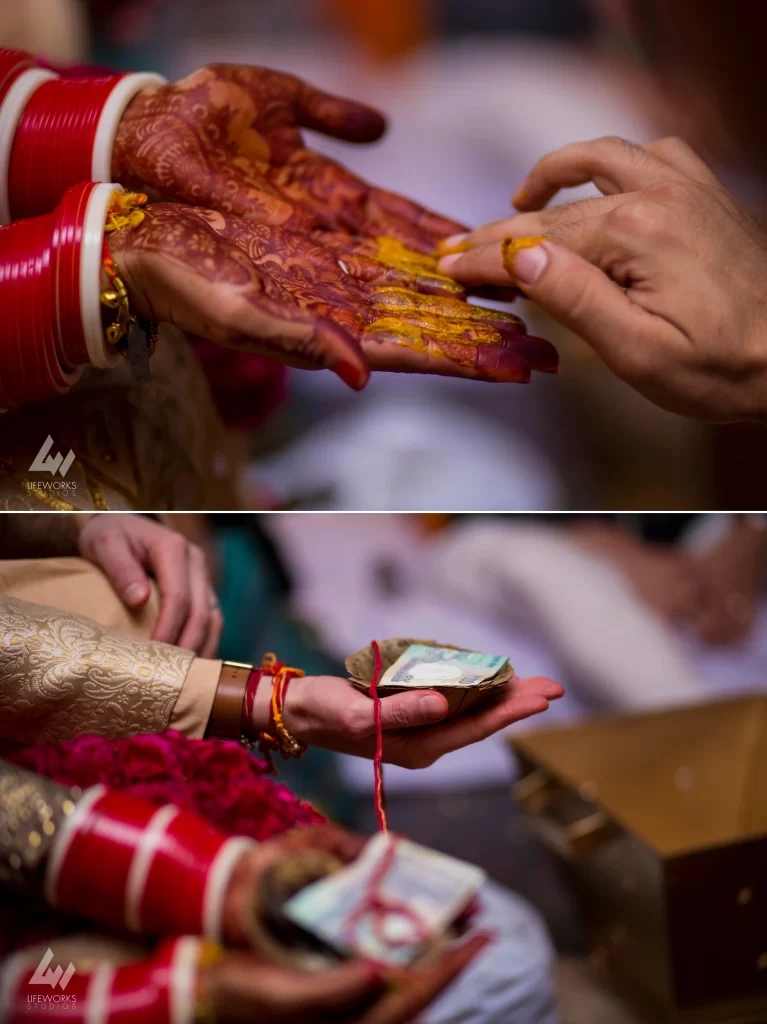 An image capturing the ceremonial application of haldi on the bride's hands during the wedding day, symbolizing blessings, purification, and the auspicious beginning of marital rituals in Hindu tradition.