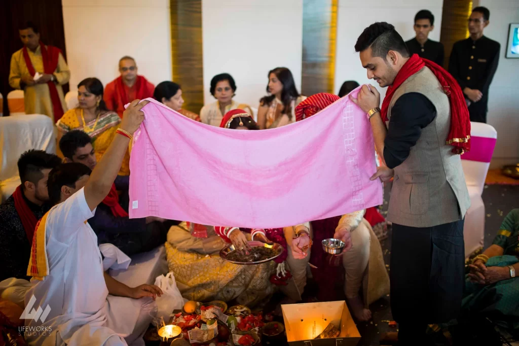 An image depicting the bride and groom performing puja (ritual worship) during their wedding day, symbolizing spiritual devotion and the sanctity of their union in Hindu tradition.