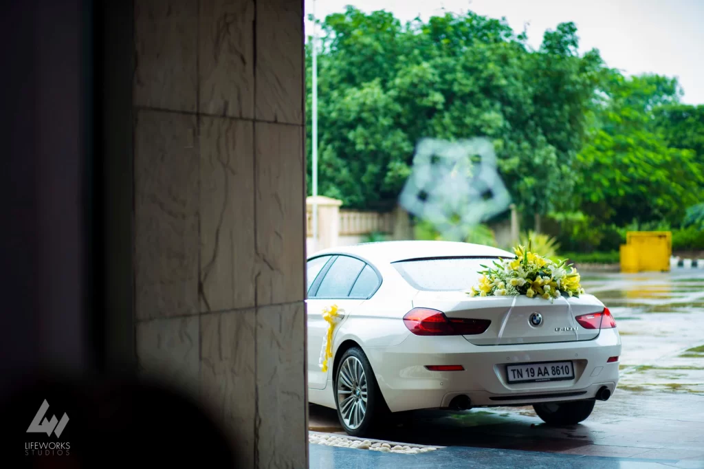 An image capturing a beautifully adorned car, elegantly decorated to transport the bride and groom during their wedding day, symbolizing the commencement of their journey into matrimony