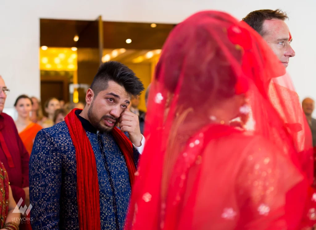 An image of the bride's brother expressing poignant emotions during her bidai, symbolizing the heartfelt farewell and the bond between siblings during this significant moment.