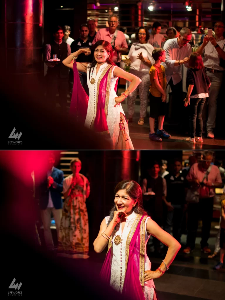 Guests joyfully dancing at a Mehendi celebration, showcasing vibrant traditional attire and lively movements as they participate in the festive event.