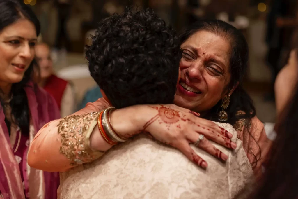 The emotional moment of bidai as the bride leaves her family home, surrounded by loved ones, symbolizing the start of a new chapter in her life.