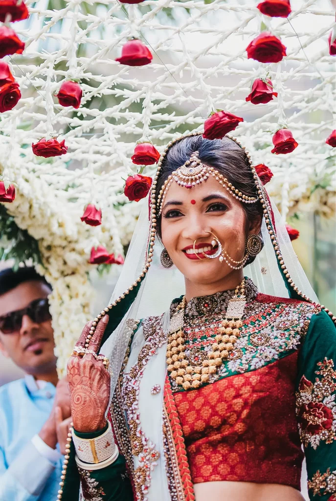 An Indian bride adorned in traditional attire, exuding elegance and grace on her special day, showcasing the cultural richness and beauty of her wedding ensemble.