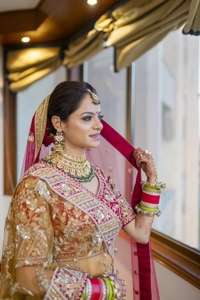 An Indian bride adorned in traditional attire, exuding elegance and grace on her special day, showcasing the cultural richness and beauty of her wedding ensemble.