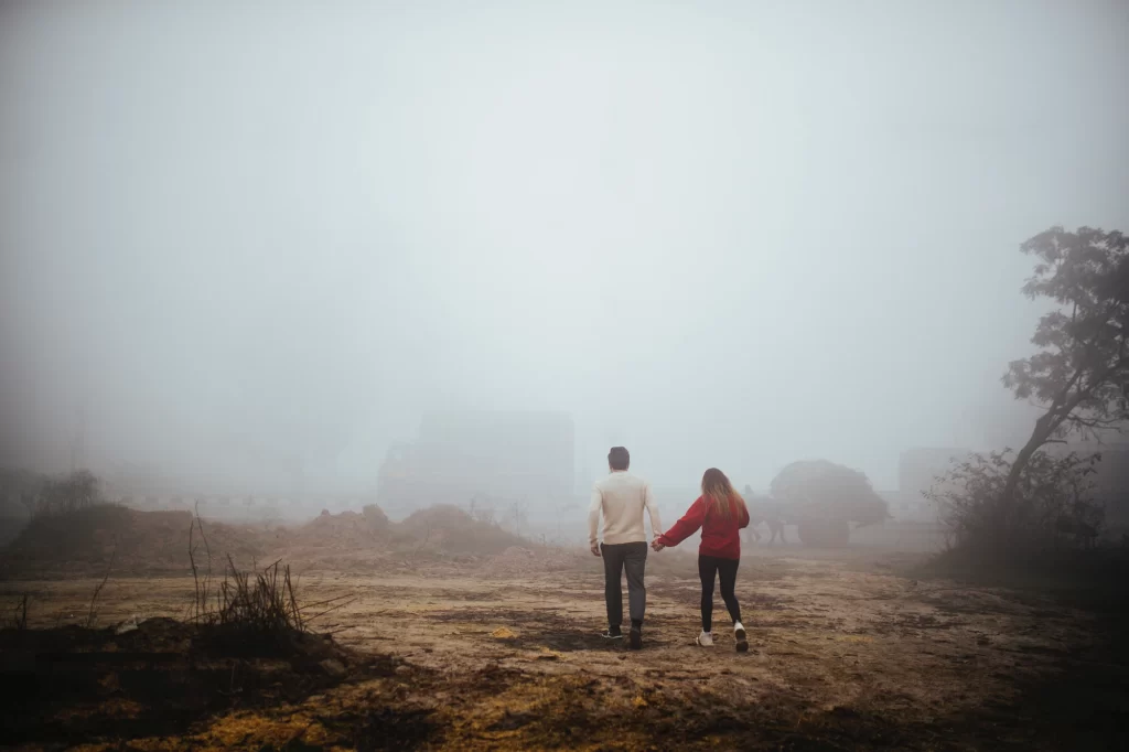 A romantic pre-wedding shoot in rishikesh captures a couple walking hand in hand, their backs to the camera. The image portrays the couple's intimacy and devotion as they journey forward together, symbolizing their commitment to each other.