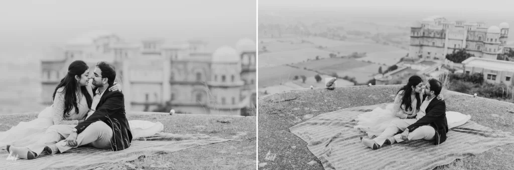  smiling couple stands embraced at the top, overlooking a stunning landscape as they pose for their pre-wedding photo shoot.