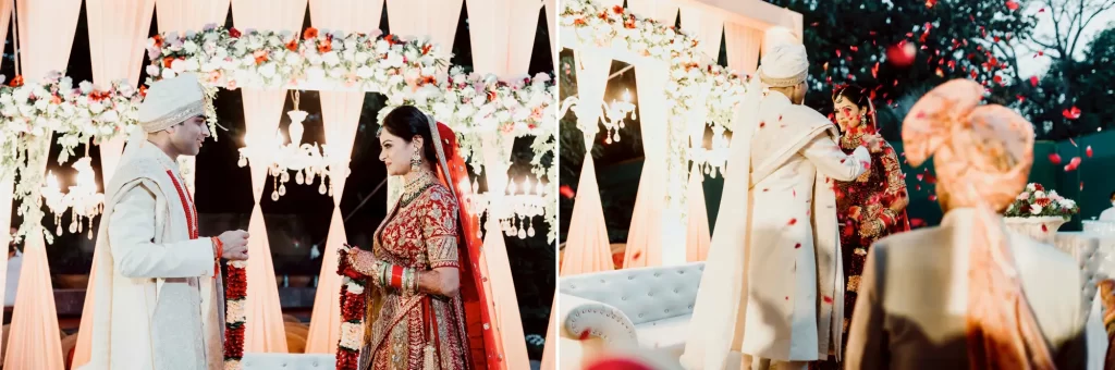 An Indian bride and groom exchanging varmala (garlands) in a traditional ceremony, symbolizing the union of their spirits and the beginning of their marriage, surrounded by festive decor and loved ones.