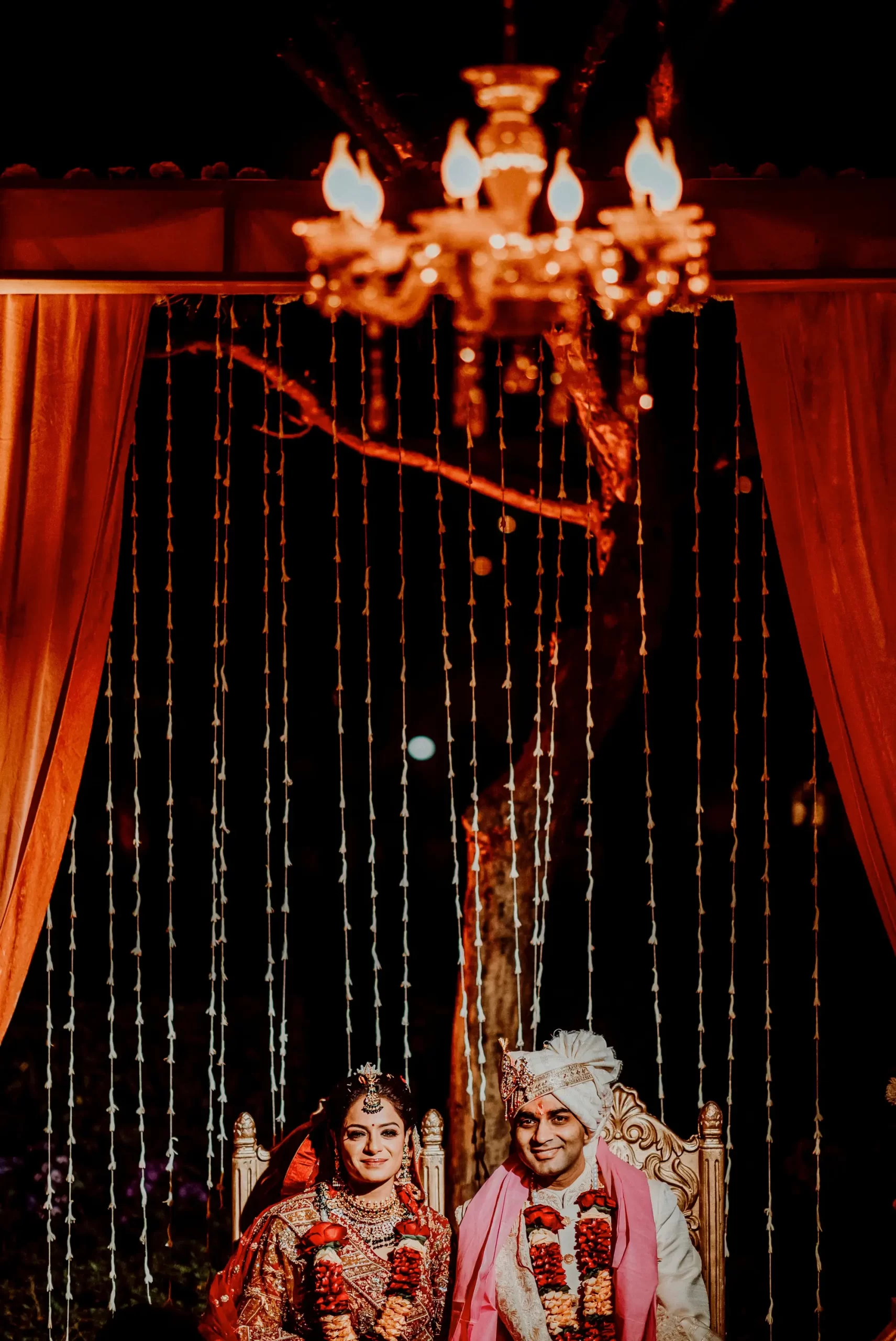 A couple taking part in a traditional wedding ceremony at the mandap, marking the beginning of their marital union.