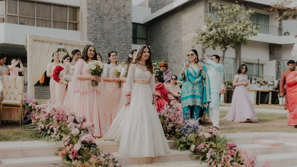 A bride in a beautiful lehenga walking down the aisle at her wedding, radiating joy.