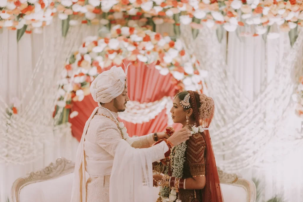 Traditional Indian wedding custom captured as the couple exchanges varmala garlands, a moment filled with love and tradition