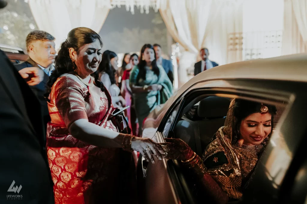 A teary-eyed bride bids farewell to her family as she prepares to embark on her new journey with her partner.