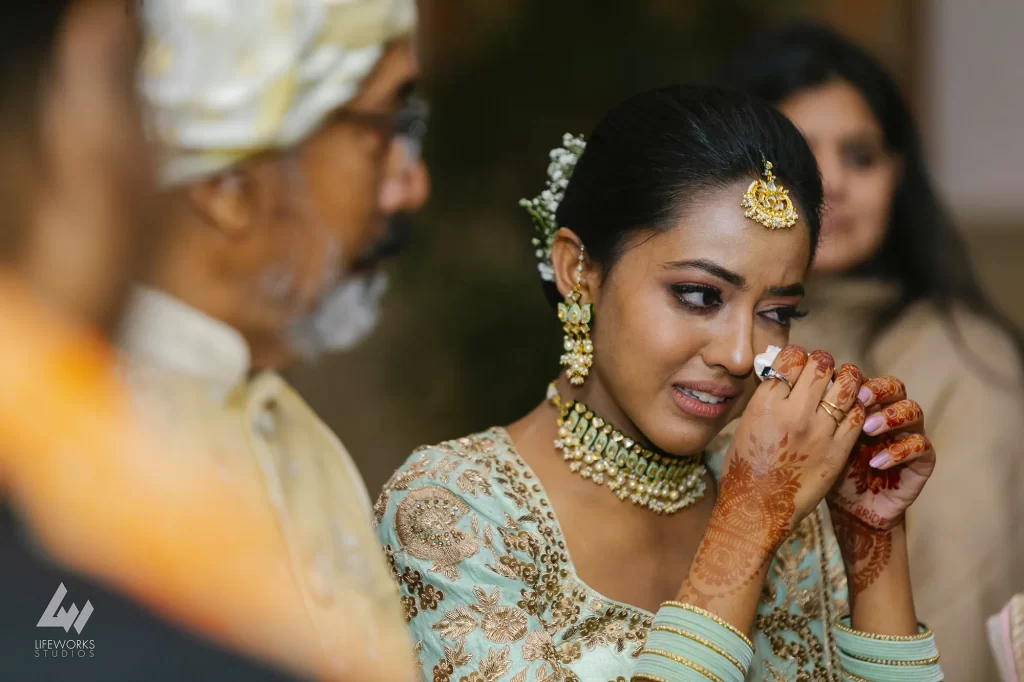 Candid Photography - Emotional farewell scene as sister departs post-wedding, tears shed