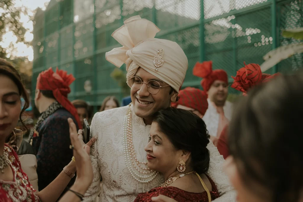  A groom elegantly walks towards the wedding venue, exuding confidence and anticipation as he approaches the auspicious celebration.  