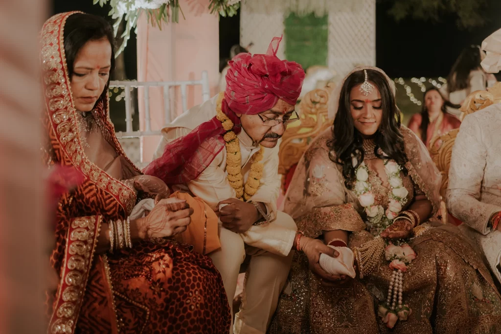 A beautiful bride and elegant groom performing traditional rituals at their luxurious destination wedding ceremony at Jaypee Palace in Agra.