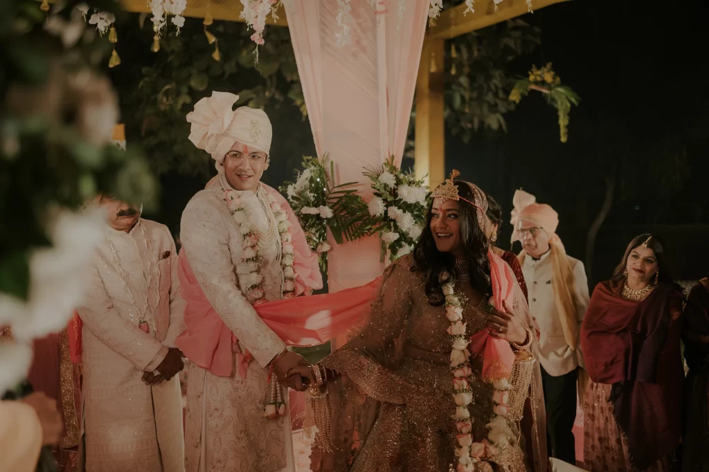 Pristine decor surrounds the bride and groom as they participate in sacred rituals during their destination wedding at Jaypee Palace, Agra.