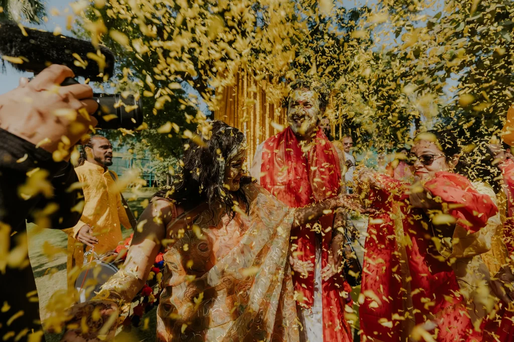 Floral arrangements adorning the vibrant ambiance of a haldi ceremony, adding a touch of natural elegance to the celebration.