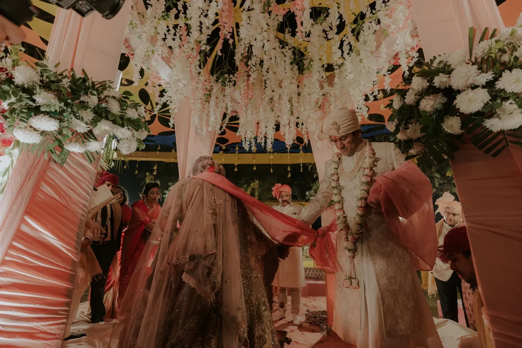 Intricate rituals unfold as the bride and groom exchange vows at their lavish destination wedding ceremony at Jaypee Palace, Agra.