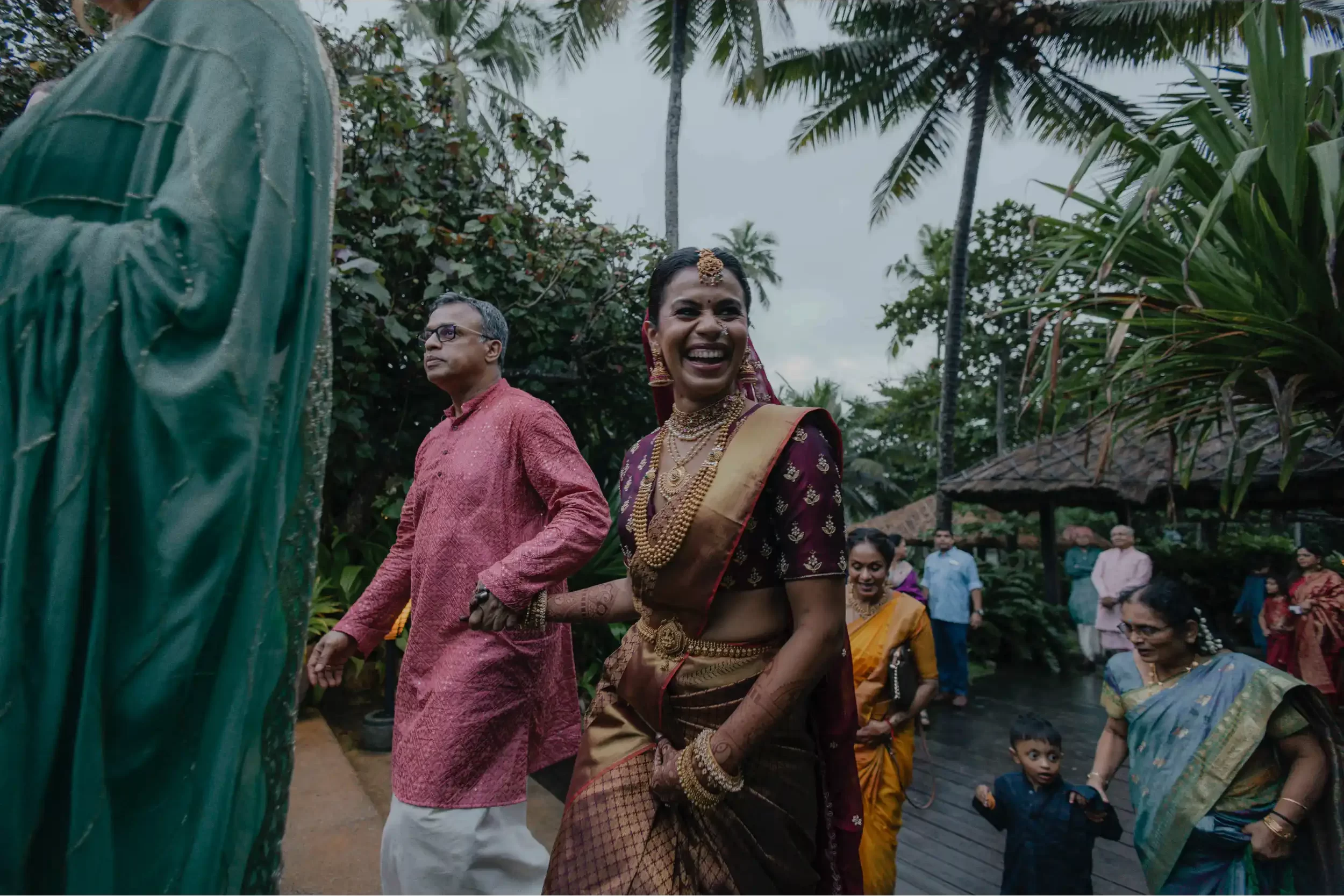 An ethereal moment captured as the bride walks towards her partner, her smile lighting up the path during her bridal entry.