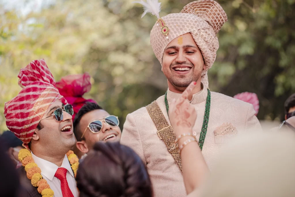 Groom participates in pre-wedding rituals with cultural reverence and joyful anticipation, embracing the traditions wholeheartedly.