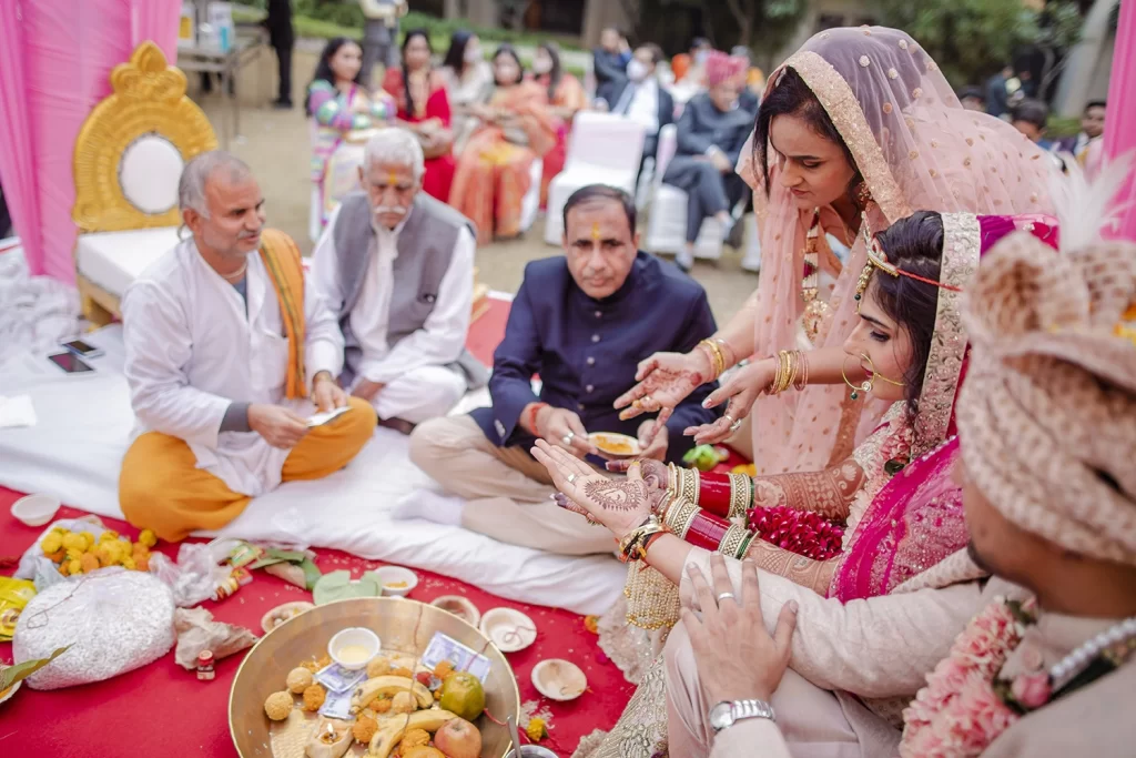 The couple performs meaningful wedding rituals, capturing the essence of their love and dedication in a cherished ceremony.