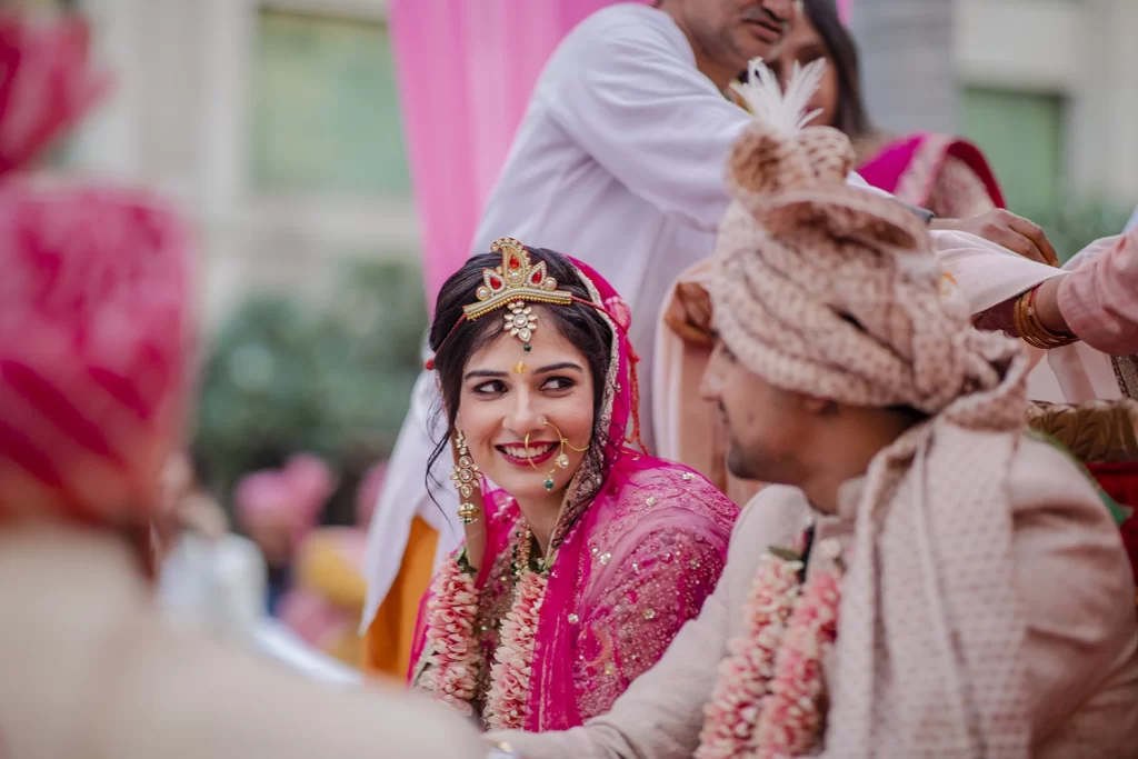 Heartwarming scene of the bride and groom immersed in wedding rituals, symbolizing their union and love in a sacred ceremony.