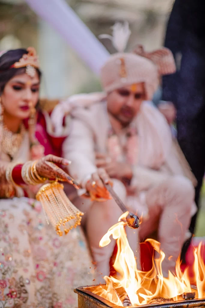 oyful image of the bride and groom participating in traditional wedding customs, sharing moments of love and unity.