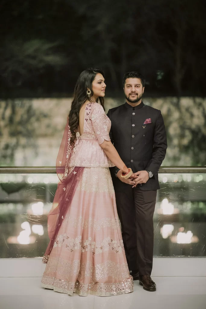 Bride and groom pose elegantly at The Oberoi, Delhi, for their destination wedding photography, radiating joy and love."
