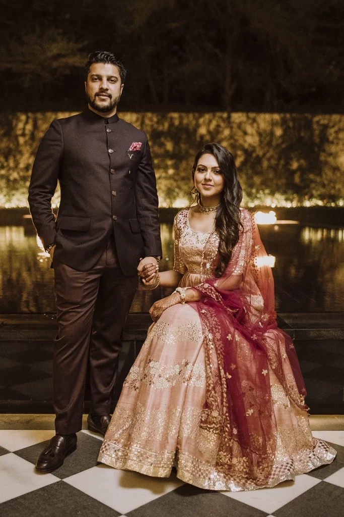 Bride and groom pose elegantly at The Oberoi, Delhi, for their destination wedding photography, radiating joy and love."
