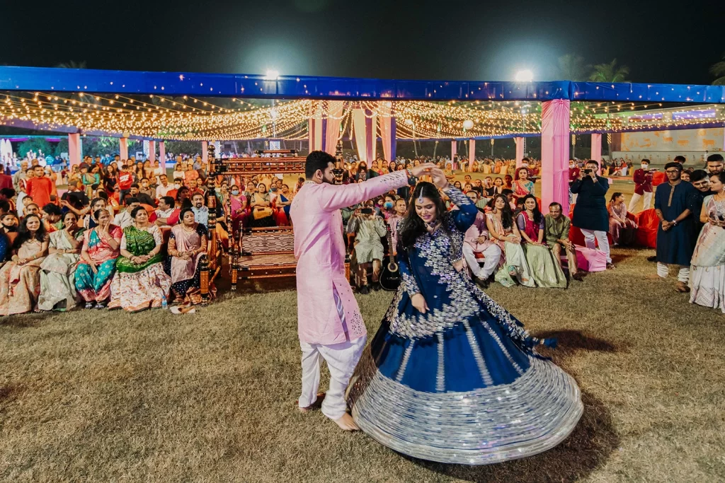 The bride and groom joyfully dance during their sangeet, expressing happiness, love, and a lively celebration of their union.