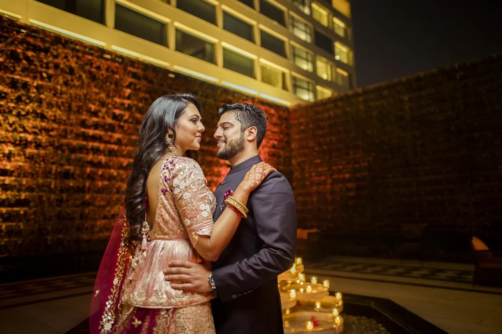 Romantic couple gazing into each other's eyes, embracing at The Oberoi, Delhi, capturing a heartfelt moment of connection.