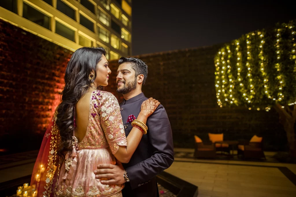 Romantic couple gazing into each other's eyes, embracing at The Oberoi, Delhi, capturing a heartfelt moment of connection.