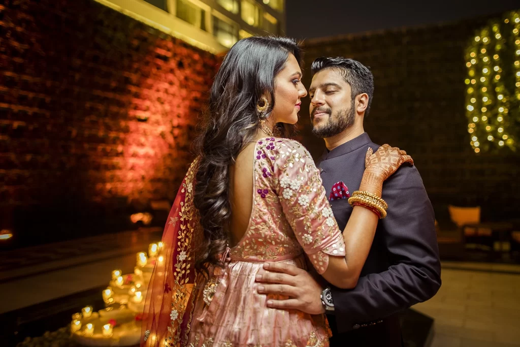 Romantic couple gazing into each other's eyes, embracing at The Oberoi, Delhi, capturing a heartfelt moment of connection.