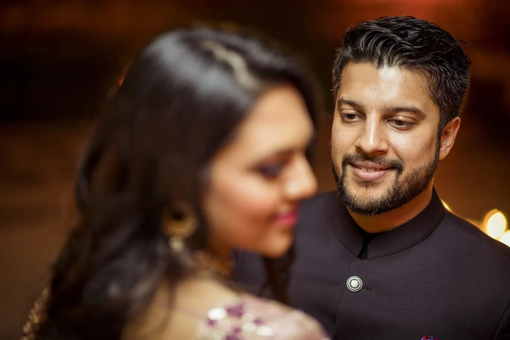 Couple enjoying a candid photo session at The Oberoi, Delhi, standing close and sharing tender moments