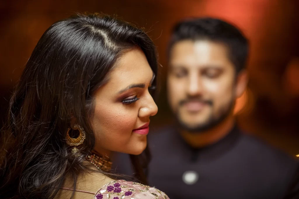 Couple enjoying a candid photo session at The Oberoi, Delhi, standing close and sharing tender moments.