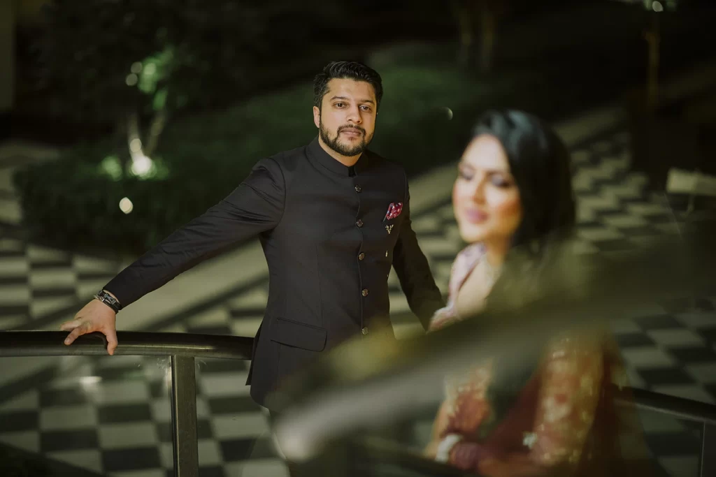 Couple sharing a tender embrace in a picturesque setting at The Oberoi, Delhi, during their destination wedding photoshoot