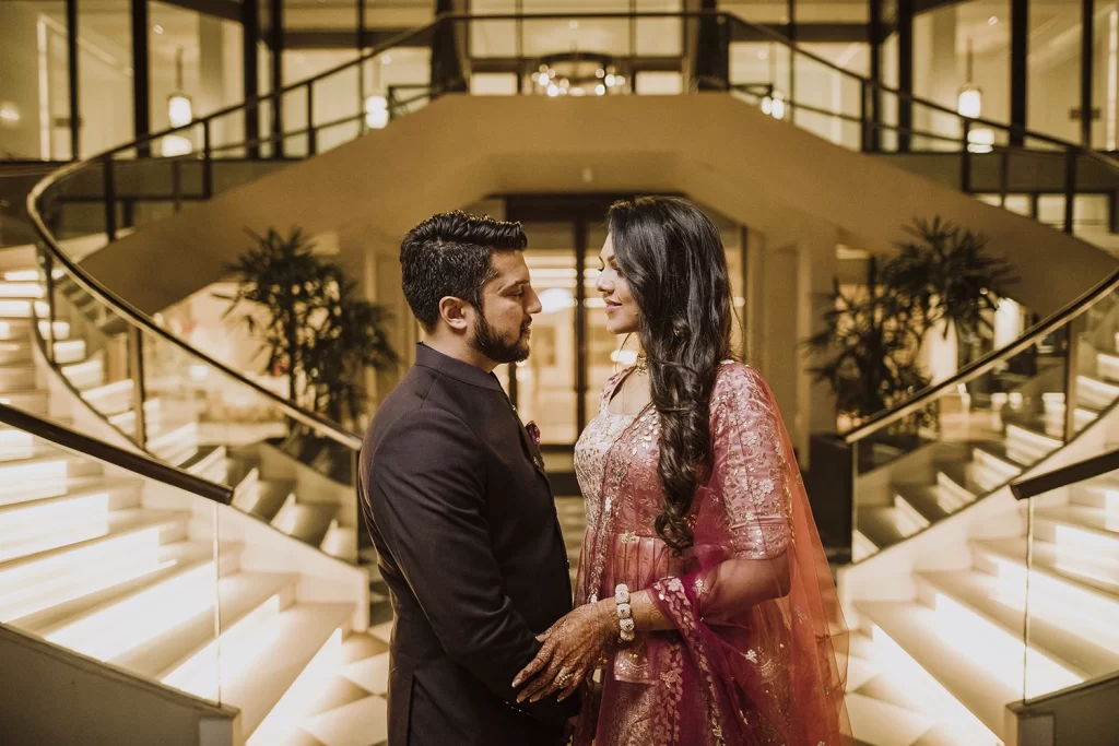 A couple shares intimate and candid moments during a photo session at The Oberoi, Delhi, filled with warmth and tenderness.