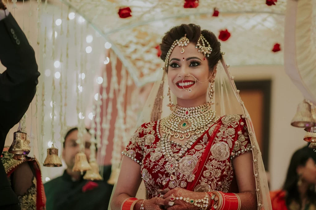 A bride in a beautiful lehenga walking down the aisle at her wedding, radiating joy.