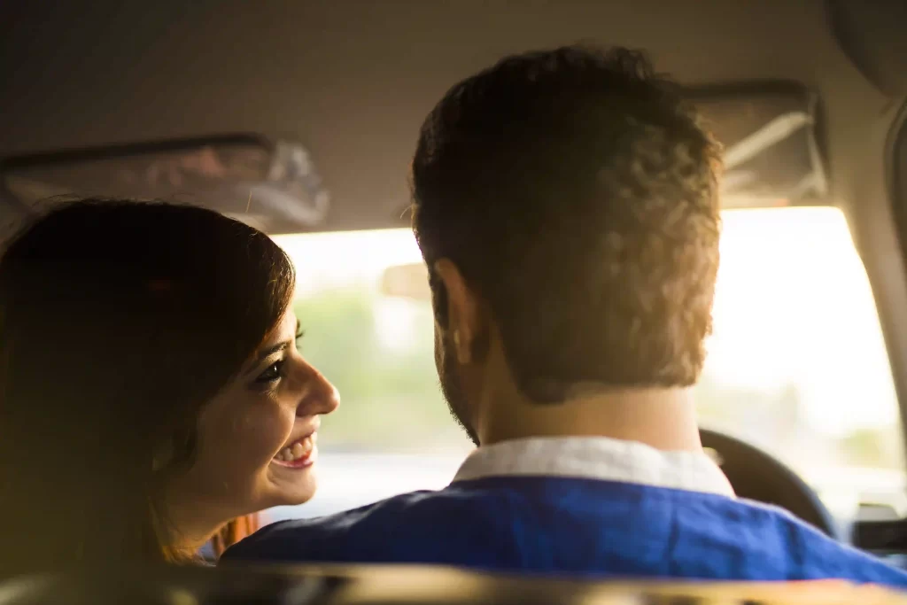 Playful moments captured inside the car near sandy shores of Goa during a pre-wedding shoot.