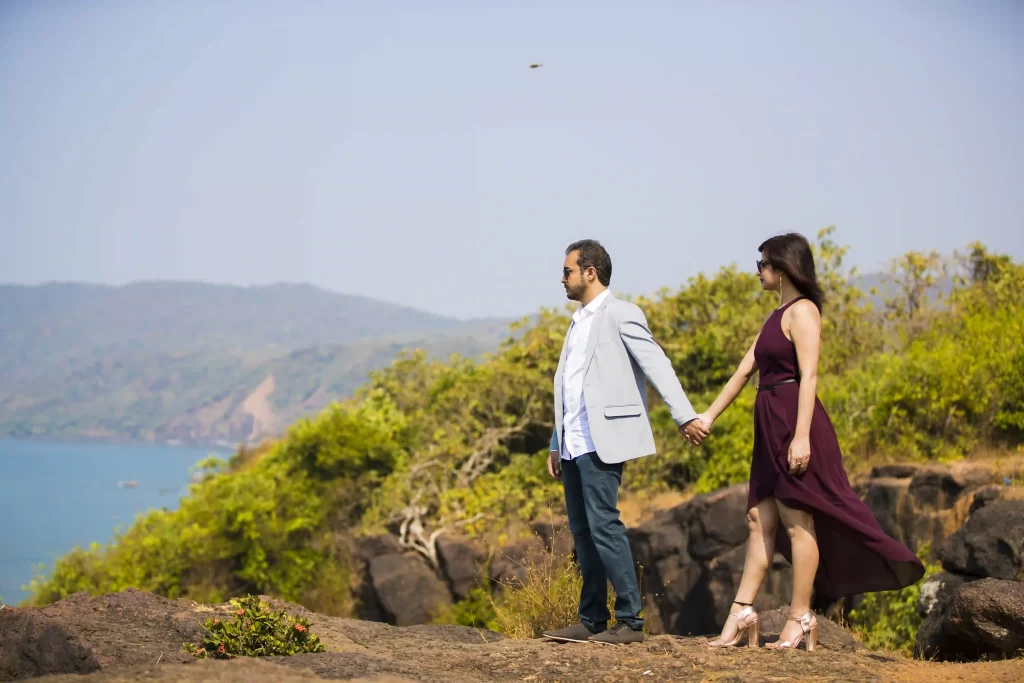 Couple embracing on a scenic beach during their pre-wedding shoot in Goa.
