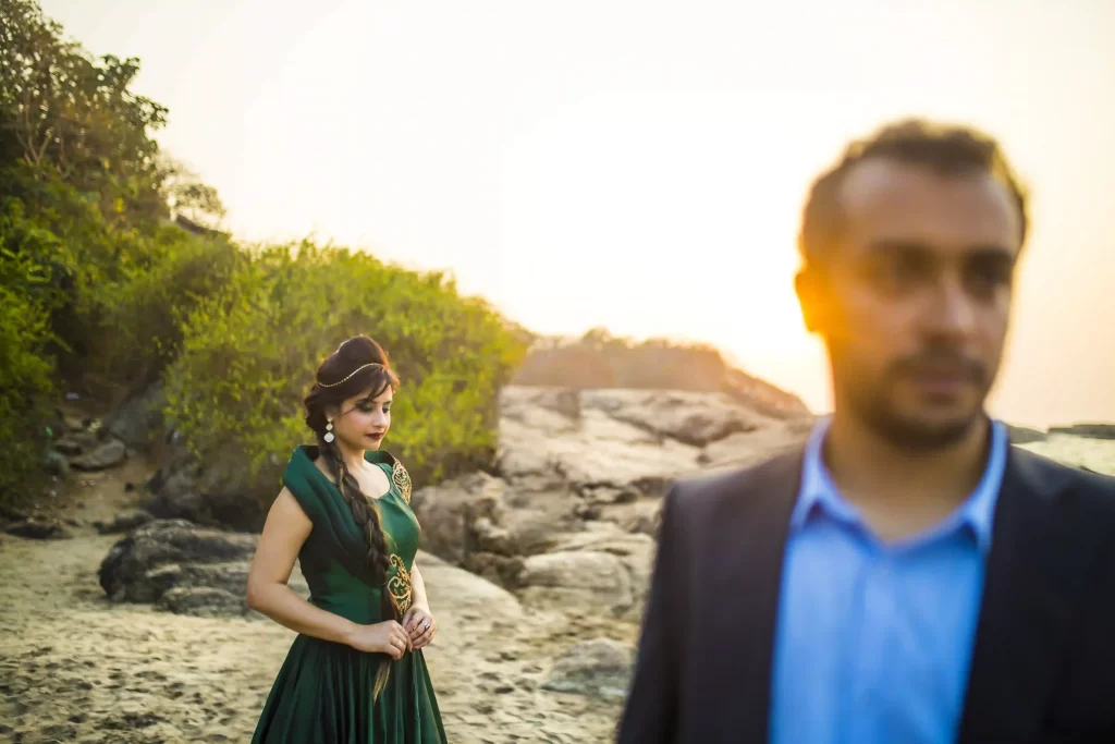 Captivating couple portrait with colorful Goan architecture in the background.
