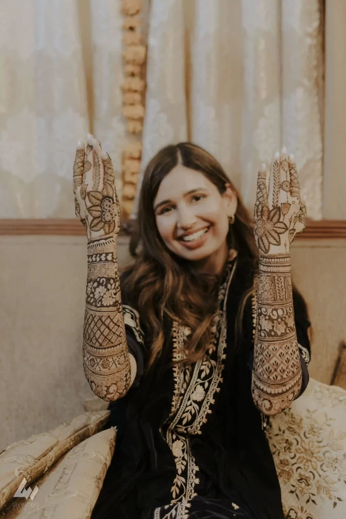 Close-up of detailed mehndi designs featuring traditional motifs on a bride's palm.