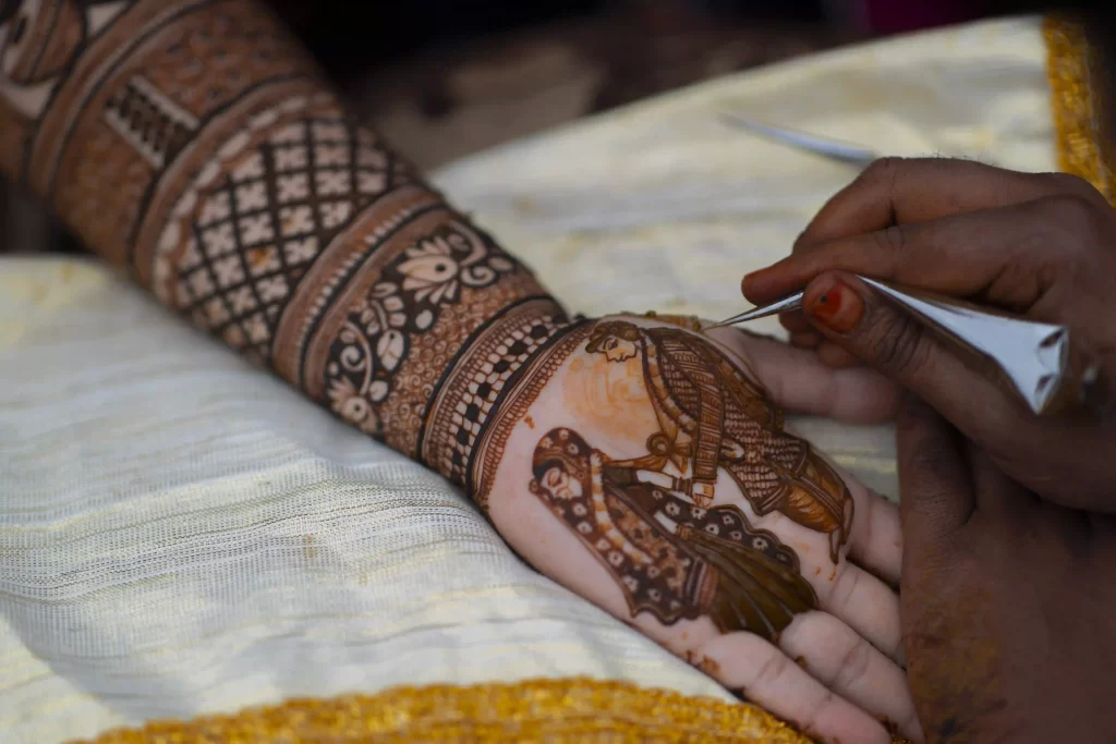 Close-up of detailed mehndi designs featuring traditional motifs on a bride's palm.