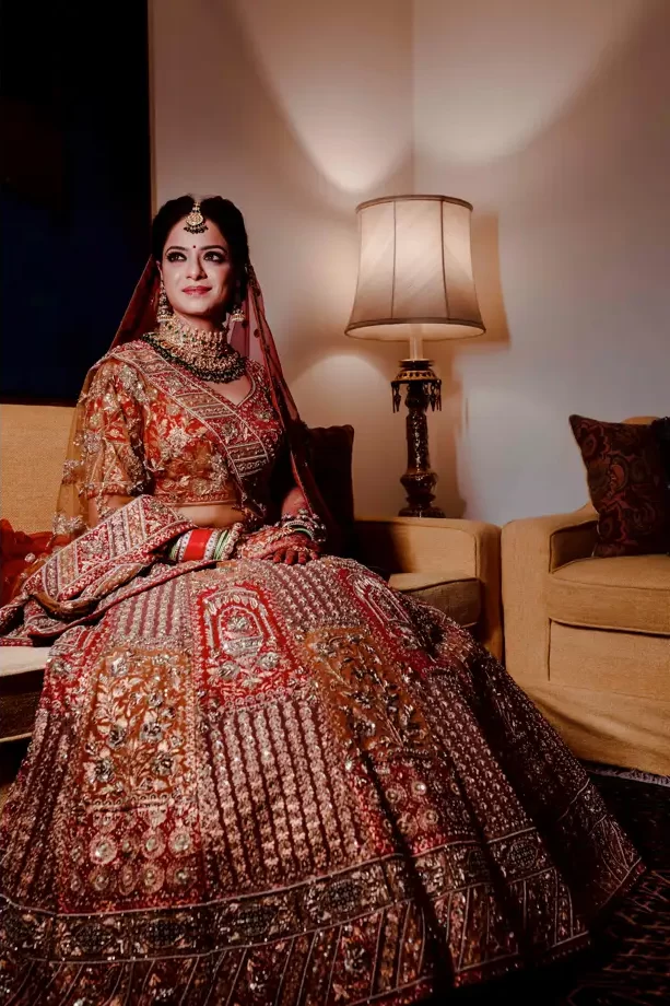 A bride, in full wedding attire, sits elegantly for her portrait after getting ready for the ceremony.