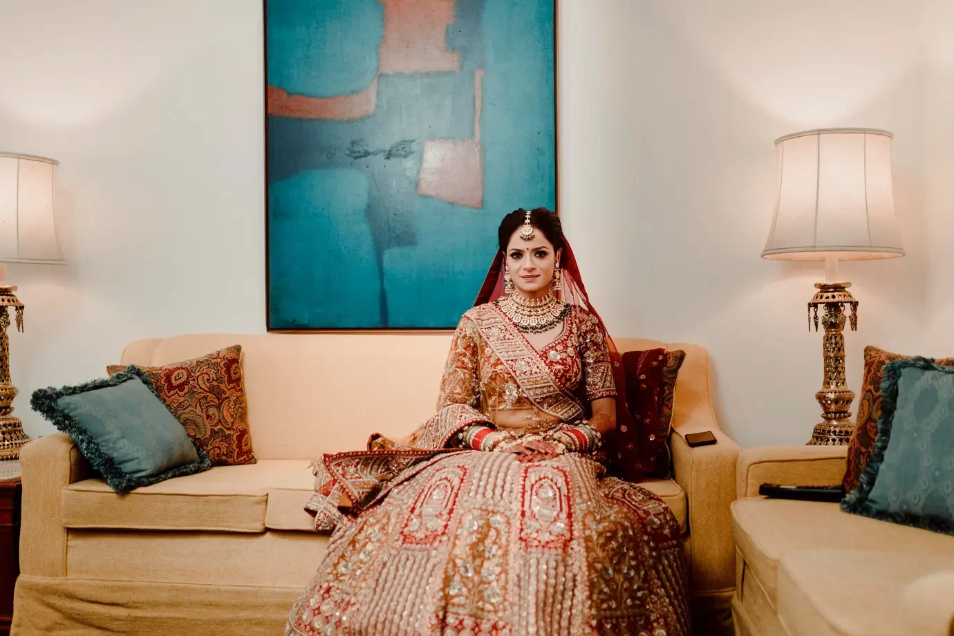 A bride, in full wedding attire, sits elegantly for her portrait after getting ready for the ceremony.